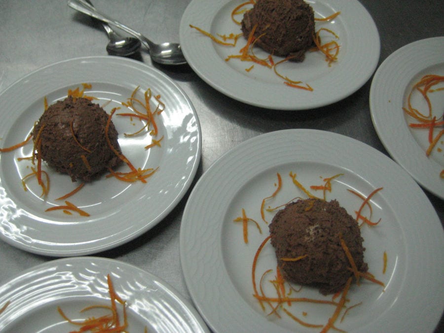 plates with one ball ice chocolate cream with slices of orange peel at 'Eleonas' each one